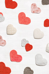 Valentines day concept, knit hearts valentine as creative pattern, handmade colored crochet heart on white wooden table, diy gift for romance holiday, symbol of love. Festive background