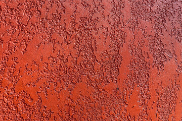 Close-up, texture of a red facade made of decorative plaster.