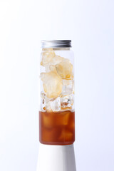 Plastic bottle with iced Americano in the white background.