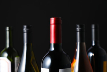 Black background and various luxurious wine bottles.