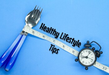 cutlery, measuring tape and alarm clock with the words healthy lifestyle tips