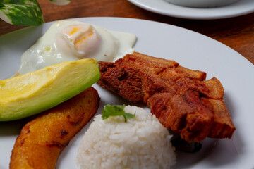 Fried egg with fried pork and sweet plantain for breakfast
