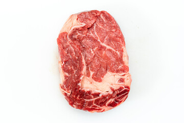 Obraz premium Raw rib eye steak over white background. Aerial view