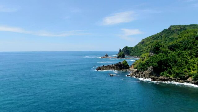 Calm waves crush on coral rock of exotic coast, Wonosari, Indonesia, aerial view
