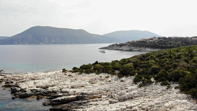 Tranquil Scenery With Boats On The Ocean In Alexia Beach, Greece - aerial drone shot