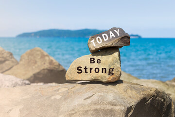 Inspirational text written on stones at the beach with sea view