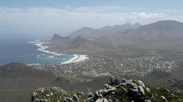 Wide shot. Spectacular late morning views from Hangklip hiking trail summit of Pringle Bay, the Atlantic Ocean and the Hottentots-Holland Mountain range in Cape Town South Africa.