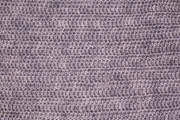 薄い茶系の編み物地の模様。