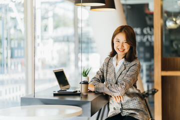 Asian woman working on a laptop computer,Working in the office with laptop concept,Young Asian...