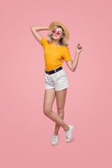 Stylish woman in summer outfit in studio