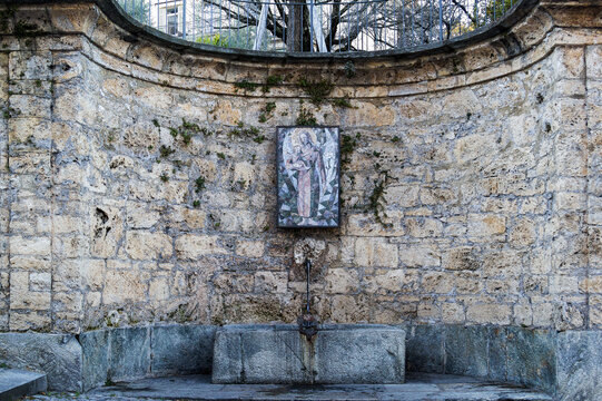 The ancient holy fountain at the side of the famous Cathedral of Saint Lawrence (Built in 818) in Lugano on the road of via borghetto.