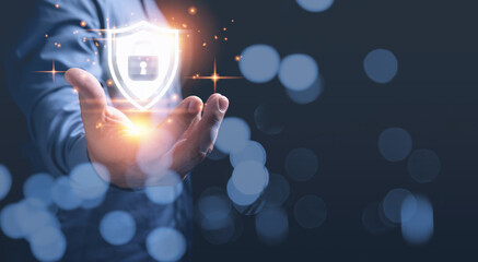 A businessman holding padlock on shield icon protection personal data in a virtual world. Cybersecurity protection, technology, shield icon, business network security, internet online concept.