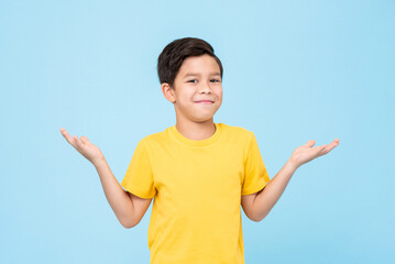 Puzzled mixed race boy shrugging shoulders