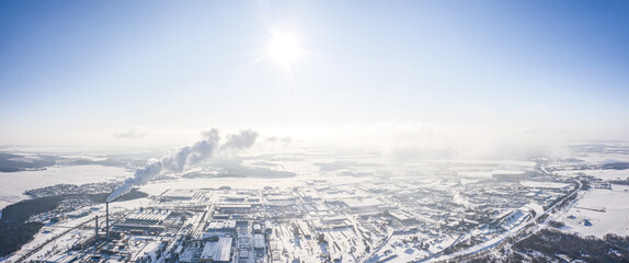 aerial panoramic view of urban industrial district, covered by snow on a sunny winter day - obrazy, fototapety, plakaty