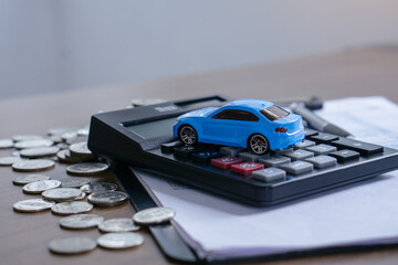 The concept of saving money. Saving money to buy a car and repairs.Miniature car...