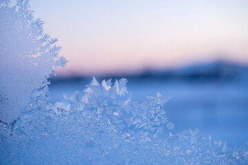 Frosty, beautiful pattern on glass. Frozen window, copy space.