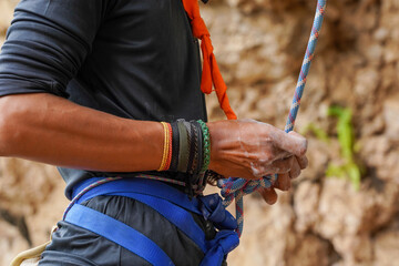 Close up shot of preparation before climbing a rock. Symbol of having good preparation before doing everything risky and uncertain.