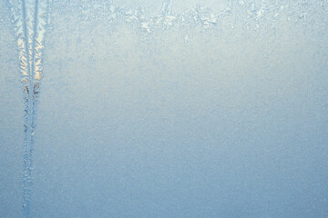 Frosty pattern on the window. Frozen glass, copy space. Background.
