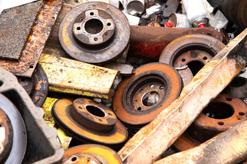 Old rusty car brakes thrown into the trash 