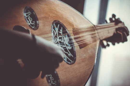 Musician Playing Note on Instrument Oud during the concert