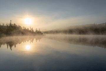 Misty Sunrise Over a Lake