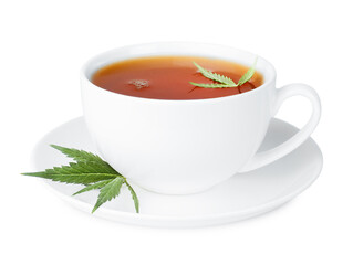 herbal tea with cannabis leaves in a white cup on an isolated white background