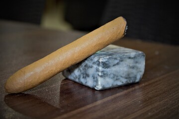 burning cigarette on marble piece