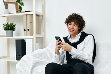 teenager in the room on the couch with the phone online learning communication