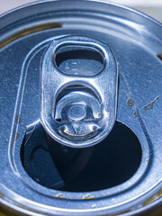 Close up of opened beverage can with green pull tab