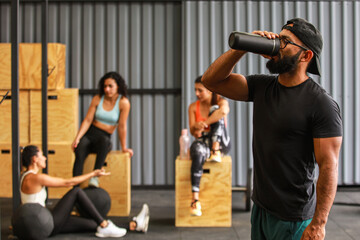 Fototapeta na wymiar Man drinking water after gym workout