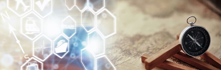 Travel and adventure search concept. Vintage aged map with a shabby book and compass. Shabby book and compass on the table.