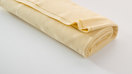 Rolls of bright colored fabric on a white background.