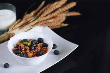 A healthy breakfast cereal with milk and fruit. Oat and corn flakes with chocolate and yogurt. The concept of healthy and vegetarian food.