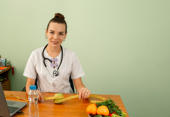 Portrait of young female nutritionist working. Diet and healthy food. Woman dietitian in medical uniform with tape measure working on a diet plan. Weight loss and right nutrition concept