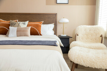 Red brown tone bedroom with wood wall , carpet and armchair. big bedroom and window.