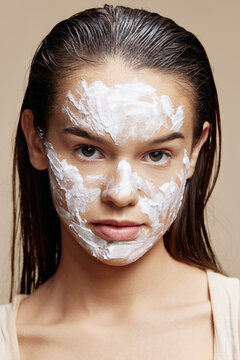 brunette face mask cream clean skin facial scrub beige background