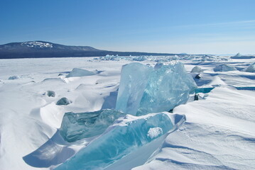 Fototapeta na wymiar The blue ice of Lake Baikal. Baikal in winter. Transparent and clean ice of Lake Baikal.