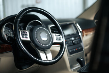 Obraz premium Modern car interior, steering wheel and dashboard