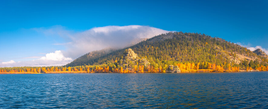 Beautiful autumn landscape. Borovoe lake and stone sculpture Jumbaktas, Burabay National park in Northern Kazakhstan.