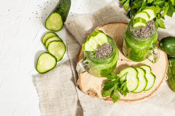 Green smoothie with cucumber in a glass jar. Fresh ripe vegetables, greens, and chia seeds