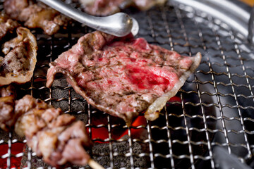 half-cooked sliced beef on the grill stove.
