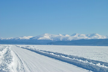 Fototapeta na wymiar Baikal. Baikal ice. Winter road on Lake Baikal. Siberia.