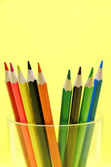 A set of colored pencils in a glass