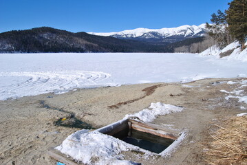 Hot springs on Lake Baikal. Ice hole, hot keys. Therapeutic thermal springs in Lake Baikal. The Republic of Buryatia.