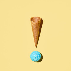 Ice cream cone with scoop of ice cream on yellow background. Minimal summer food concept.