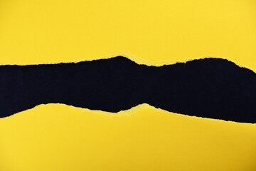 black and yellow torn and ripped sheet of cardboard paper texture background.