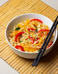 Udon noodles with chicken, pepper and sesame. Chinese food.