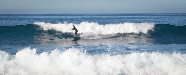 Lanzarote, Spain on Januari 3, 2022 - Surfer practicing his skills in the Atlantic ocean at Lanzarote