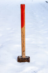 Old hammer on the snow.