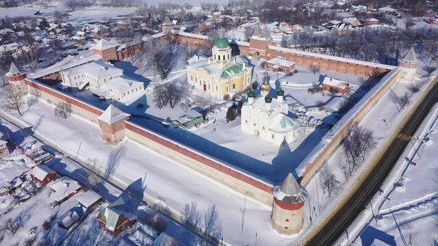 View from drone of snow covered architectural ensemble of Zaraysk Kremlin with Forerunner and St. Nicholas cathedrals on winter day, Russia